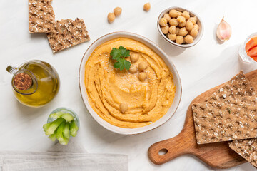 Fresh homemade hummus  with vegetables  sticks and chickpea and multigrain crackers. vegan food healthy eating