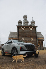 A car is currently parked in front of a wooden building structure