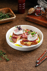 Portion of breakfast with bacon and poached egg on toast