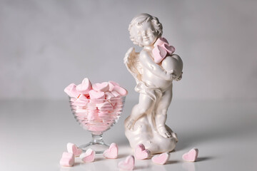 Elegant decoration with a porcelain angel and heart candies, perfect for themes like Valentine's...