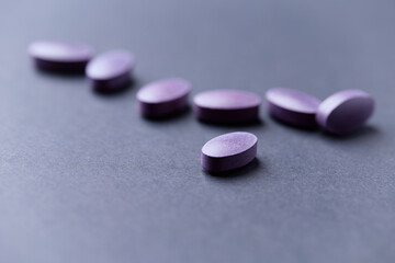 Lutein tablets. Dietary supplement on paper background. Soft focus. Close up. Copy space	