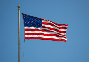 American Flag Waving in a Clear Blue Sky