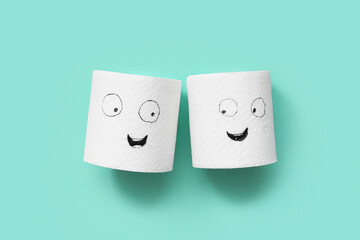 Funny paper rolls with drawn faces on color background. Friendship Day celebration