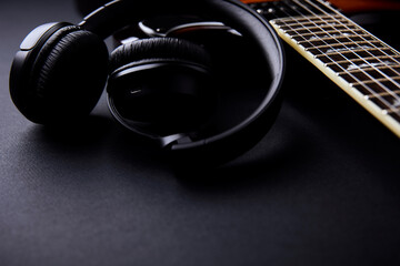 Headphones with electric guitar in the background. Soft focus. Close up. Copy space.	