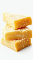 Delicious yellow cheese blocks stacked on each other, showcasing rich texture and color in a bright setting