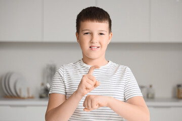 Mute boy using sign language at home