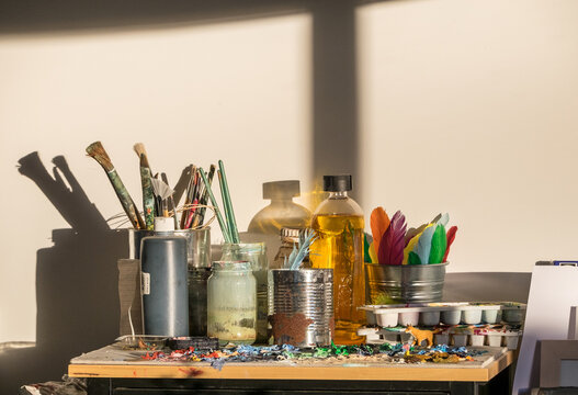 Morning light in an art studio with brushes and paint palette