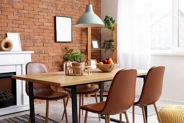 Interior of dining room with table, fireplace and shelf unit