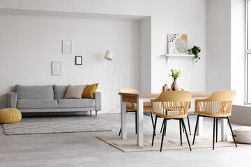 Interior of dining room with table, sofa and lamp