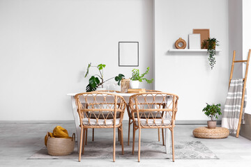 Interior of dining room with table, ladder and plants
