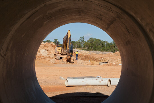 Looking through a drain pipe at an industrial building site