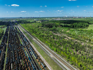 Aerial drone photo of Cargo train terminal, railway hub. Railway wagons on the tracks in industrial area.