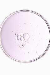 The texture of a cosmetic serum or body gel in a Petri dish.