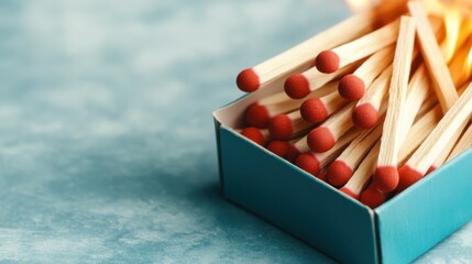 A striking image featuring a box of matches with lit matches, representing themes of spark, ignition, and creativity against a contrasting vibrant backdrop.