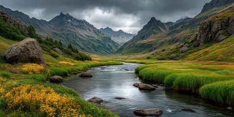 Stunning valley landscape with flowing river amidst mountains under dramatic sky