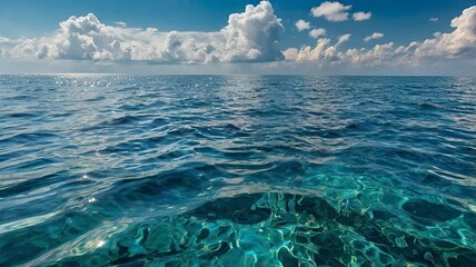 Close-up view of sea water and cloudy blue sky. seen from the side