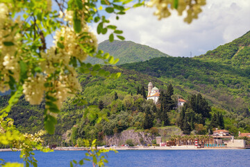 Beautiful spring Mediterranean landscape. Montenegro. Bay of Kotor near Verige Strait. View of Kamenari village and church of Holy Sunday