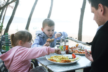 happy family eating pizza in cafe outside, lifestyle people