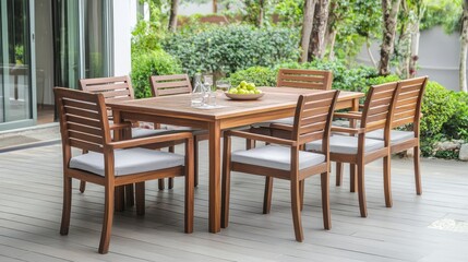 Stylish wooden outdoor table set on backyard terrace