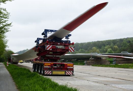 Truck transporting wind turbine blade on a country road