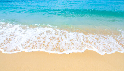 Obraz premium Beautiful sandy beach and soft blue ocean wave. Sea background