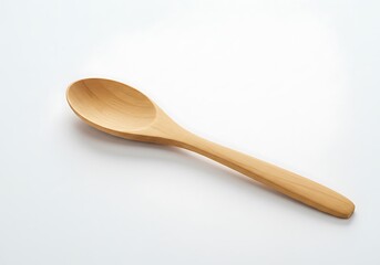 A simple wooden spoon resting diagonally on a plain white surface in a studio setting with soft light