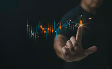 Business finance and stock market investment concept man hand touching candlestick stock chart on black background showing stock trading analysis.