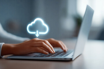 Cloud computing concept: a person working on a laptop with a cloud download icon overlay.