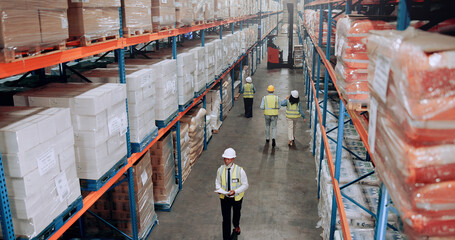 Warehouse, management and people walking for logistics, stock inventory or inspection by shelves. Above industrial employees, distribution and supply chain with safety, depot or wholesale storage