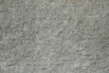 Detailed stone-like plaster texture with uneven surface gray cement wall texture with rugged, grainy surface
