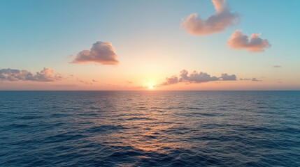 Obraz premium Serene ocean view at sunset with soft clouds and vibrant colors reflecting on water