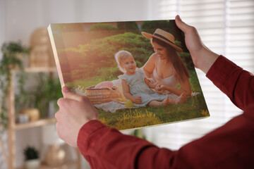 Canvas print. Woman with photo at home, closeup