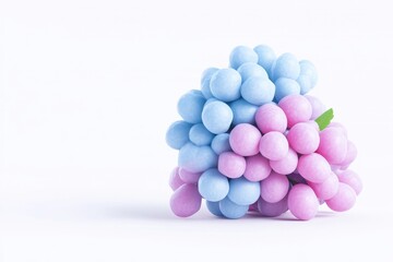 A cluster of pastel-colored spheres, light blue and pink, resembling a bunch of grapes. A small green leaf is attached at the top