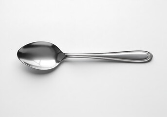 A simple studio shot showcasing a single metal spoon resting on a white background with soft lighting