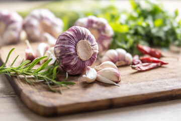 Close-up Garlic Cloves and Bulbs with rosemary salt and pepper