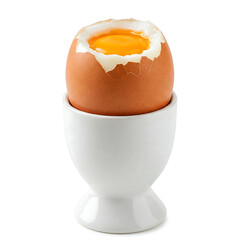 Soft-boiled egg in a brown eggshell features the top of the egg removed, revealing the runny yolk placed in a white egg cup isolated on white background
