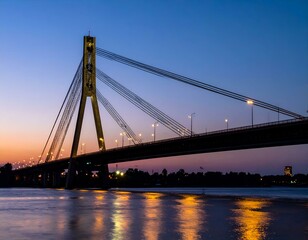 Obraz premium Illuminated cable-stayed bridge at sunset over a river. Serene twilight cityscape.