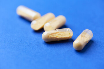 Coenzyme Q10 capsules. Antioxidants. Concept for a healthy dietary supplementation. Bright background. Soft focus. Close up. Copy space.	