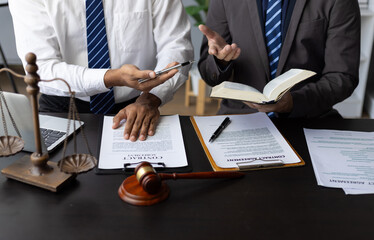 Lawyer discussing legal case and working with contract. Two lawyers deeply discussing a complex...