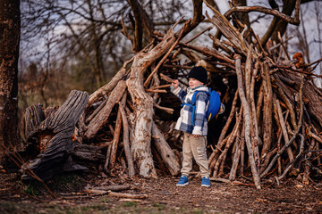 Child Playing with Stick Near Forest Fort