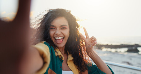 Beach, selfie and woman with peace sign, vacation and travel with profile picture, social media and ocean. Portrait, person and seaside with live streaming, tropical island or influencer with holiday