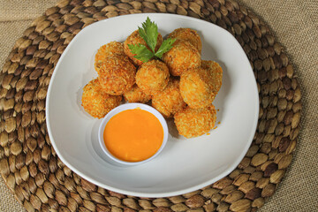 Meatball nugget dish with cheese sauce