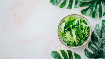Obraz premium Healthy Meal: Fresh Salad Bowl Surrounded by Tropical Leaves for a Refreshing Summer Diet