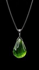 Emerald Gemstone Pendant: A mesmerizing green gemstone pendant hangs elegantly, its vibrant emerald hue accentuated against a deep black background, a perfect symbol of refined elegance.