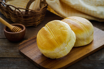 Fresh baked buns on wooden board