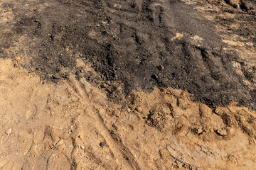 excavated pits during construction work on the road, the end of summer at the construction site