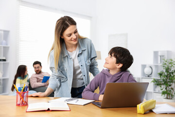 Parents helping their kids with homework at home, selective focus