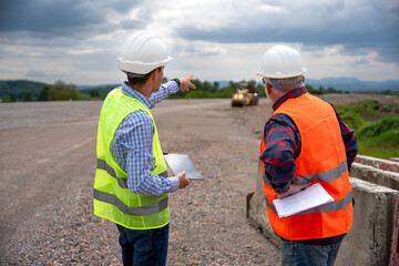 Highway engineers discuss and plan.