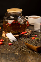 rosehip in red and green tea on the table during cooking close up