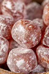 candied fruits of kumquat boiled in sugar syrup in powdered sugar, sweet candied fruits of kumquat